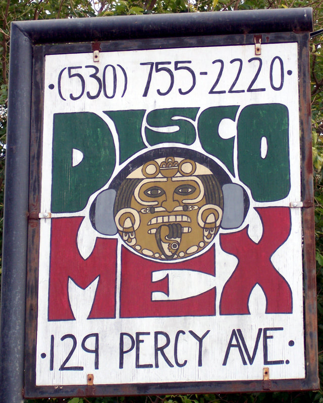 Acrylic painting of the Disco Mex music store sign in Yuba City, CA – showing Tonatiuh (the Mexica sun god at the center of the Aztec calendar) wearing headphones and listening to music, with the words “Disco Mex” in the Mexican flag colors of green and red surrounding him.