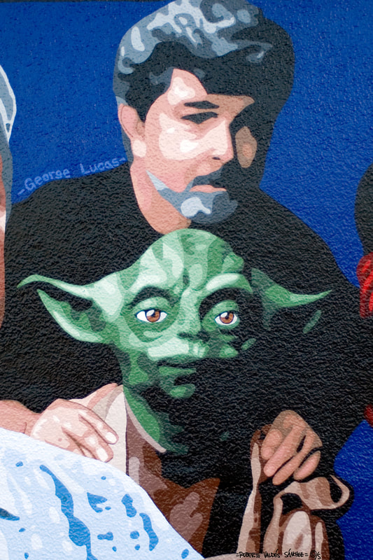 Mural art painting of filmmaker George Lucas with Yoda from Star Wars.