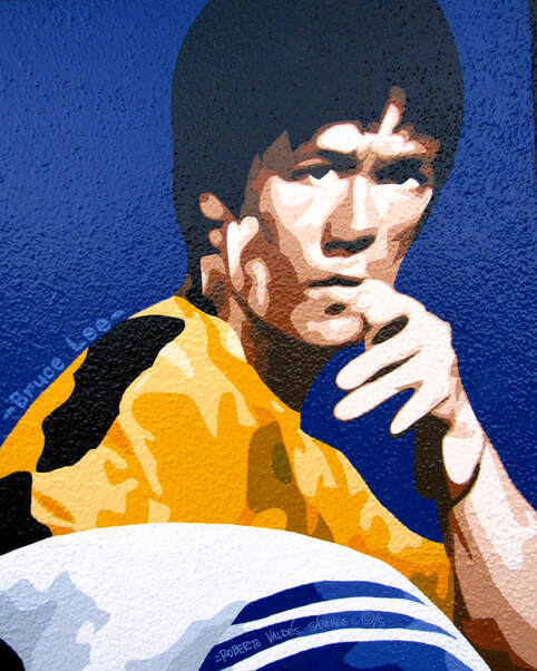 Mural art portrait painting of Asian martial artist Bruce Lee intensely looking at the viewer while in a fighting stance.