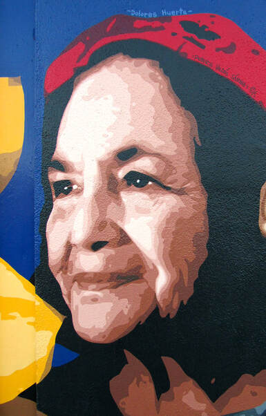 Mural art portrait painting of Chicana labor leader and civil rights activist Dolores Huerta smiling and looking to the left.