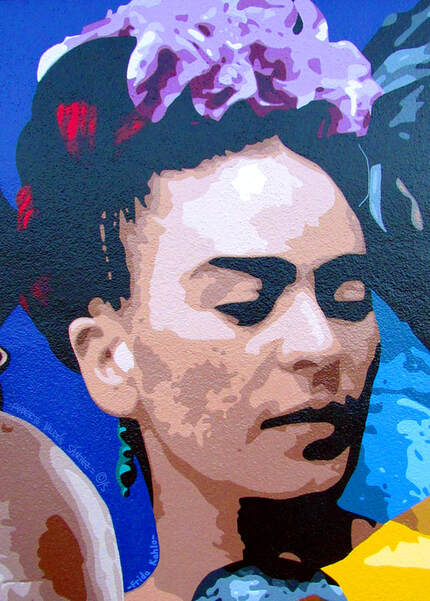 Mural art portrait painting of feminist Mexican artist Frida Kahlo, wearing flowers on her hair and looking to the right.